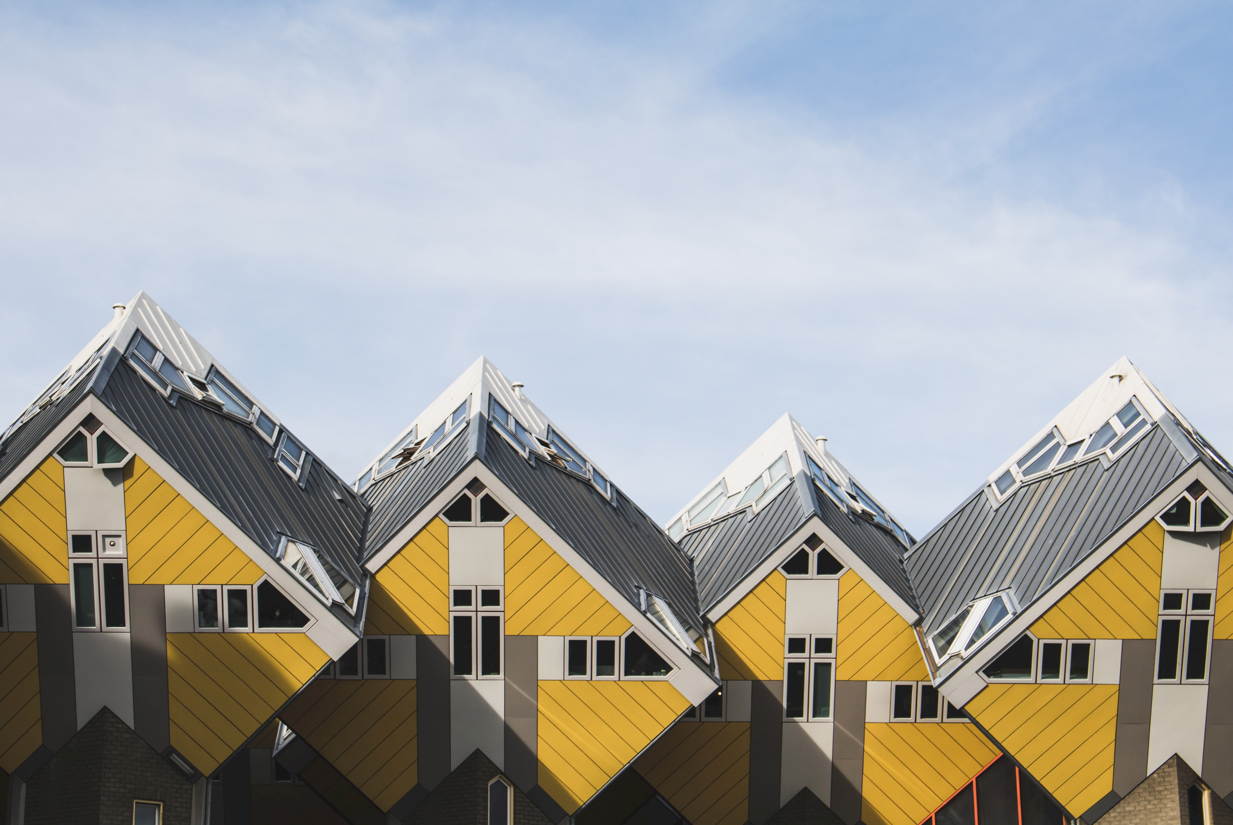 A photo of yellow and gray, cube shaped houses, at Rotterdam, The Netherlands