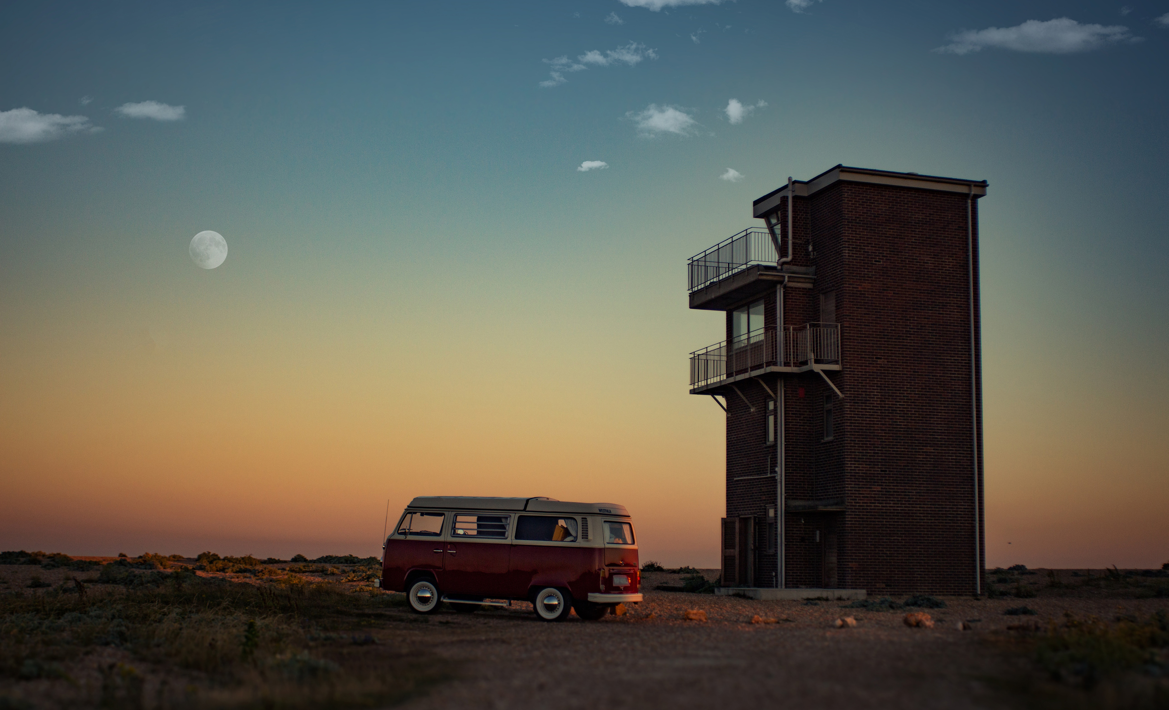 Photo called 'Feel the freedom' in Dungeness, United Kingdom, displaying a red Volkswagen Samba parked near brown house.